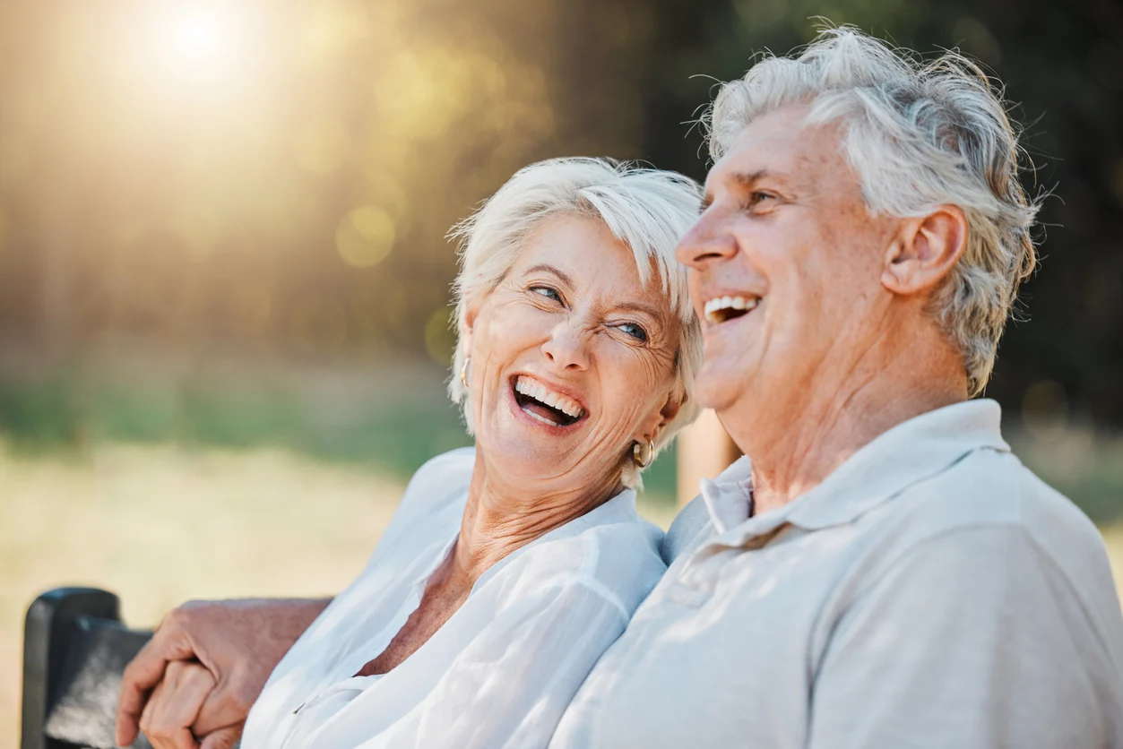 A happy older couple sharing a quiet moment together outdoors
